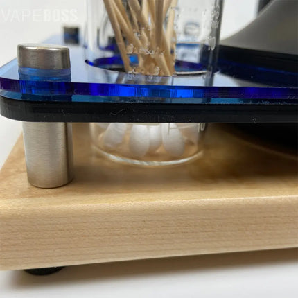 Close-up of a wooden desk organizer with glass jars and metal components.